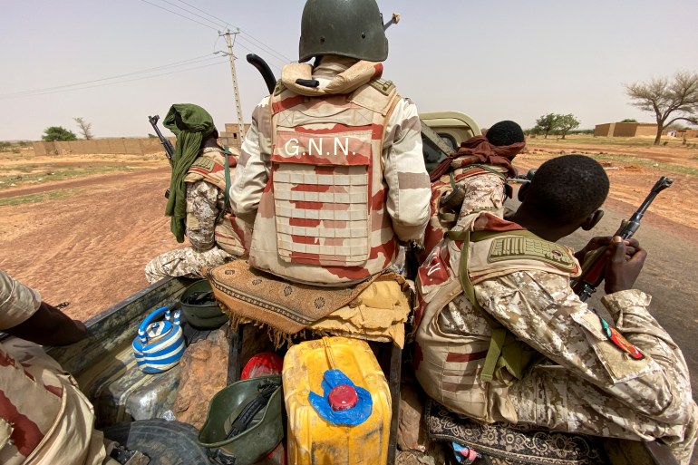A convoy of Nigerien soldiers on patrol outside the town of Ouallam, Niger