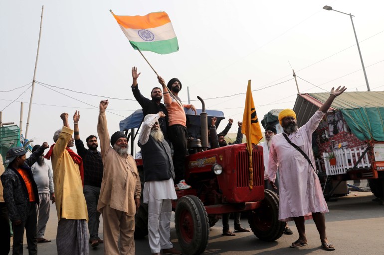 Farmers celebrate after Indian Prime Minister Narendra Modi announced that he will repeal the controversial farm laws