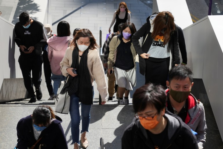People wearing face masks to prevent the spread of the coronavirus disease (COVID-19), walk at the Central District in Hong Kong, China December 1, 2021.
