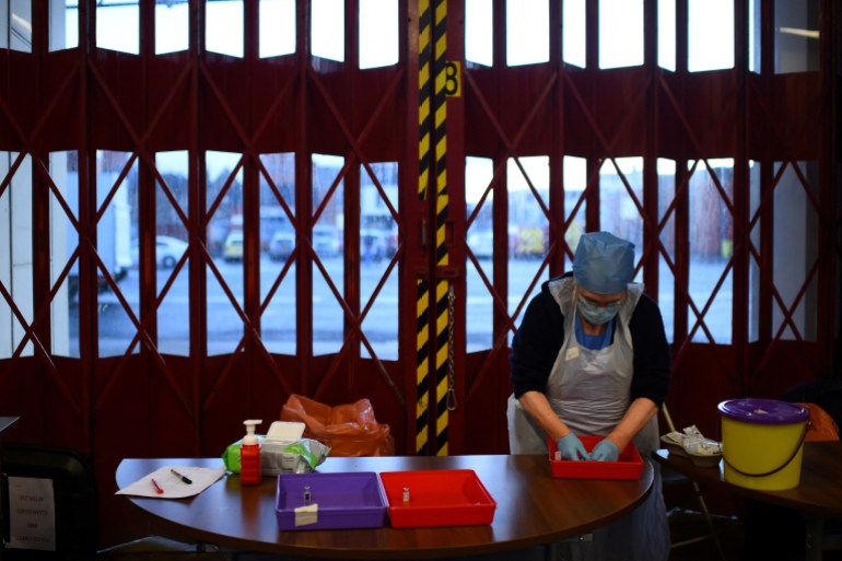 Nurse Christina McCavana prepares the vials of the Pfizer coronavirus disease (COVID-19) vaccine for use at a pop-up vaccination clinic in the Central Fire Station in Belfast, Northern Ireland,