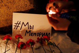 A placard in Russian reads 'We are Memorial' as supporters of the human rights group gather after Russia's Supreme Court ruled the group must be liquidated.