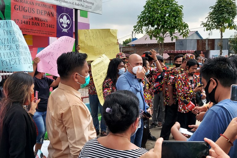 A group of parents hold a protest outside the Galilea Hosana School in Medan after a priest was accused of sexually assaulting some of the young girls attending the institution