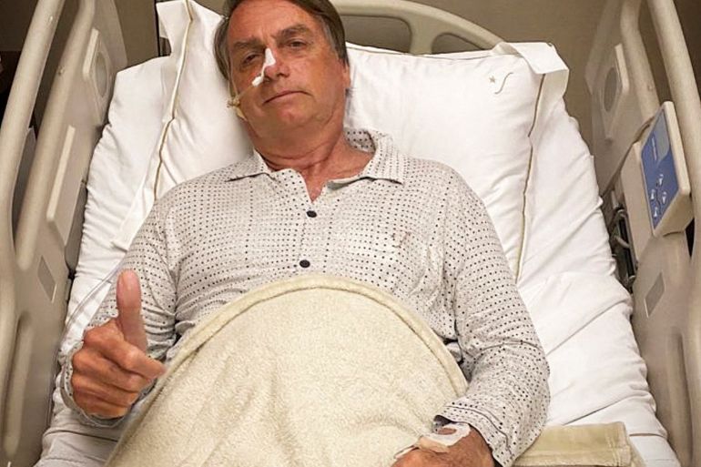 Brazilian President Jair Bolsonaro gestures from a hospital bed in Sao Paulo