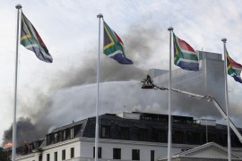 Firefighters work at the national parliament as the fire flared up again, in Cape Town.