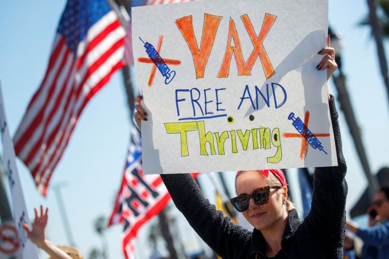 Protesters hold signs in California decrying vaccine mandates during the COVID-19 pandemic