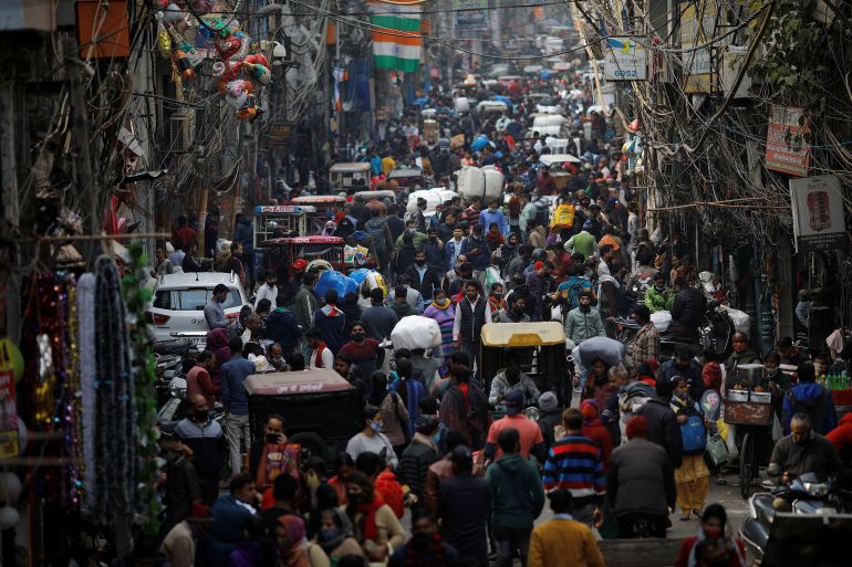 People shop at a crowded in the old quarters of New Delhi, India