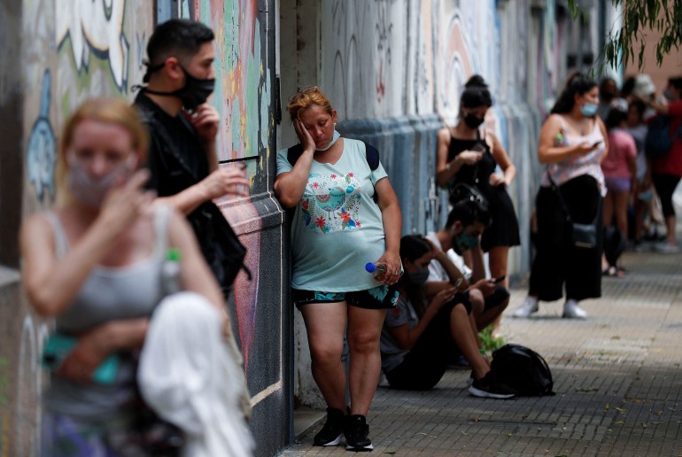 People wait in line to be tested for the coronavirus disease in Buenos aIRES