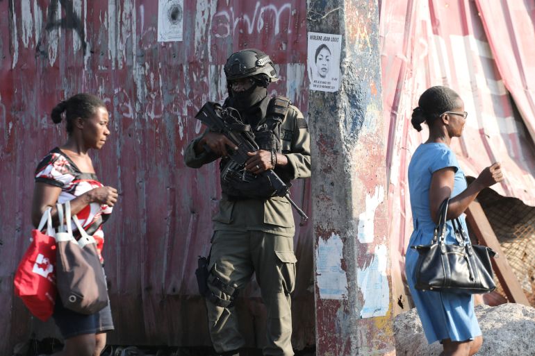 A member of Haitian Armed Forces stands guard near the presidential palace