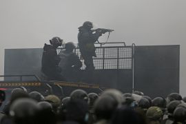 Kazakh security forces are seen on a barricade in Almaty