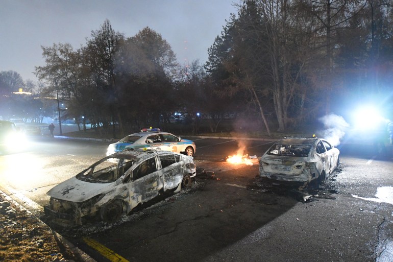 Damaged police cars during protests caused by fuel price increase in Almaty, Kazakhstan