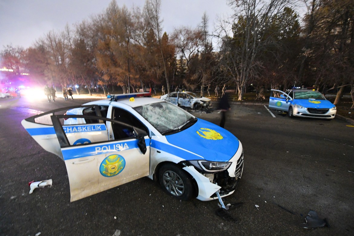 A damaged police car during protests triggered by fuel price increase in Almaty, Kazakhsta