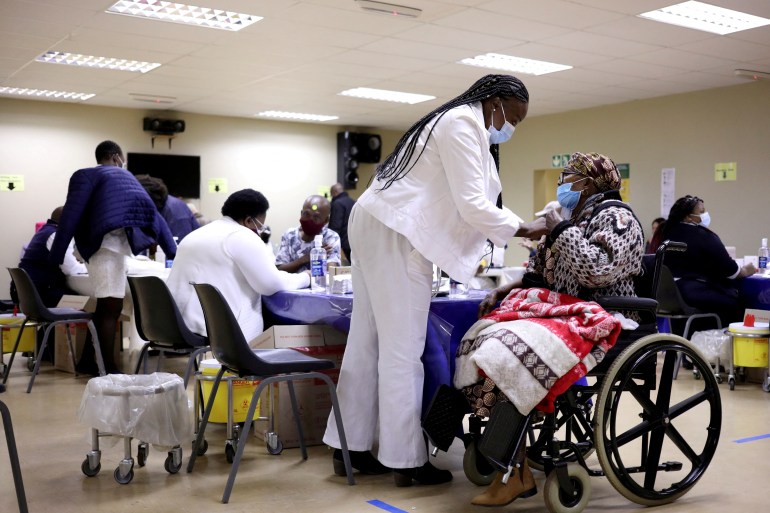 a woman in a wheelchair receives an injection