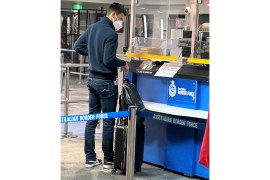 Novak Djokovic stands at a booth of the Australian Border Force at the airport in Melbourne, Australia