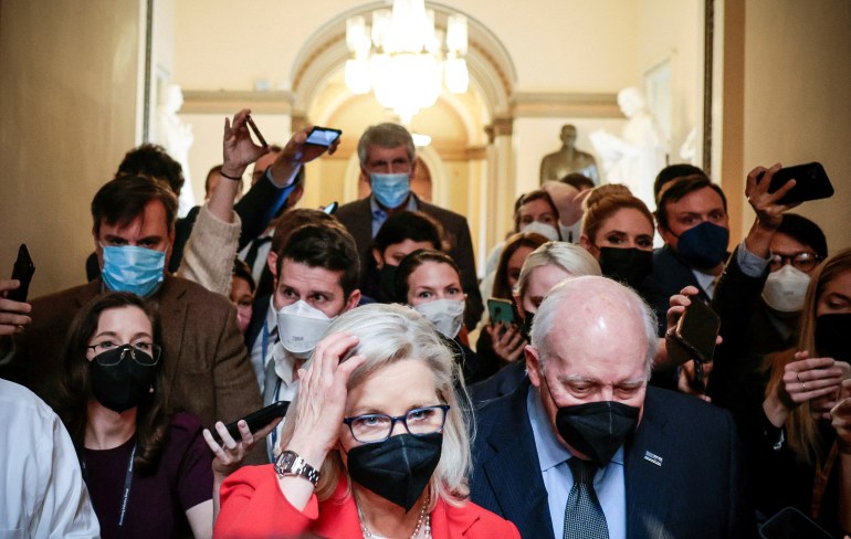 Liz Cheney and her father, former Vice President Dick Cheney, are pursued by reporters 