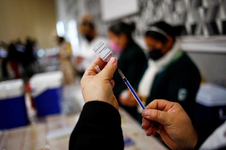 A health worker prepares an injection with a dose of the AstraZeneca coronavirus disease (COVID-19) vaccine, in Ciudad Juarez, Mexico