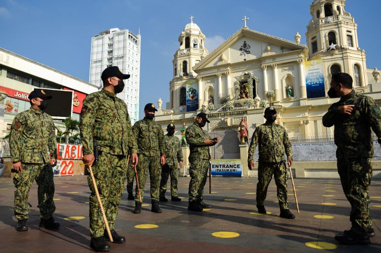 Police block a church in Manila to prevent worshippers from entering