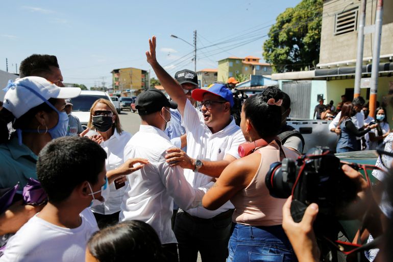 Venezuelan opposition candidate for Barinas State Governor Sergio Garrido greets people outside a polling station