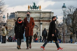 People wearing protective face masks walk in the Tuileries Gardens in Paris amid the coronavirus disease (COVID-19) outbreak in France, January 5, 2022