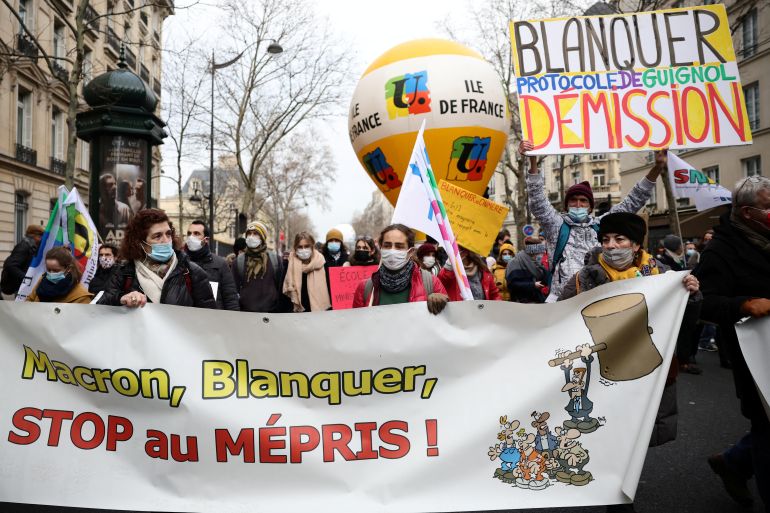 Demonstrators assemble on the streets in Paris, France carrying posters and banners