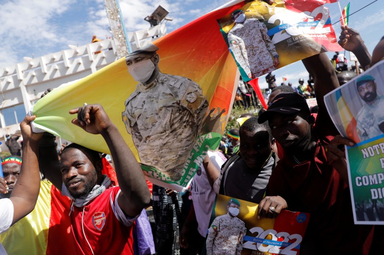 Supporters hold a poster of Mali's Colonel Assimi Goita during a protest