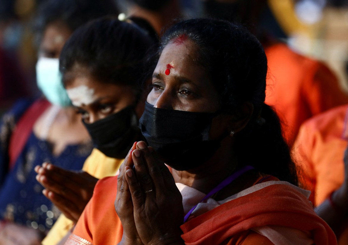 A Hindu devotee recites a prayer at Sri Subramaniar Swamy Temple during celebrations of Thaipusam, which resumed with tight health protocols after a one-year hiatus due to the coronavirus disease (COVID-19) pandemic, at Batu Caves, Malaysia, January 18, 2022. REUTERS/Hasnoor Hussain