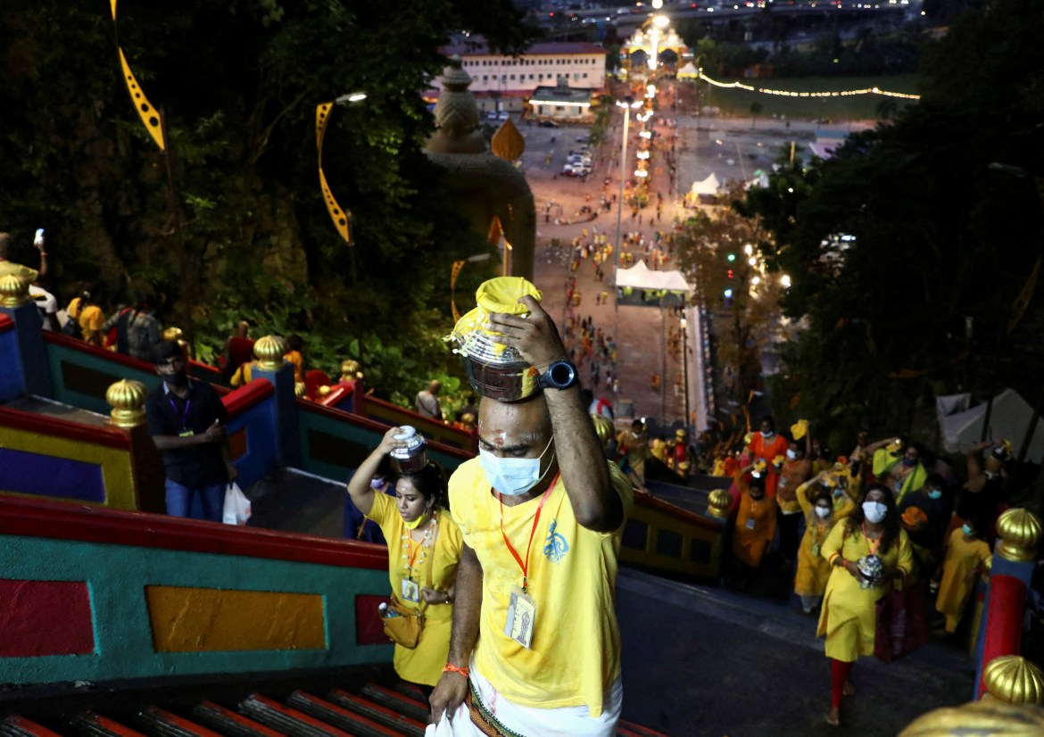 Hindu devotees climb the 272 steps to Sri Subramaniar Swamy Temple during celebrations of Thaipusam, which resumed with tight health protocols after a one-year hiatus due to the coronavirus disease (COVID-19) pandemic, at Batu Caves, Malaysia, January 18, 2022. REUTERS/Hasnoor Hussain