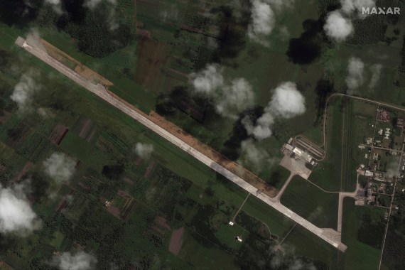 A satellite image shows the main runway of the Fua'amotu International Airport partially blocked