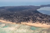 Am aerial view from a New Zealand surveillance flight shows heavy ash blanketing Nomuka in Tonga [New Zealand Defence Force/Handout via Reuters]