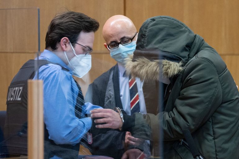 Syrian doctor, 36, known as M. by German media goes on trial accompanied by his lawyer Oussama Al-Agi in Frankfurt