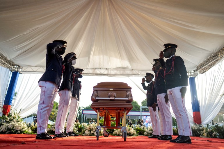 Presidential guard standing beside coffin of assassinated Haitian president Jovenel Moise