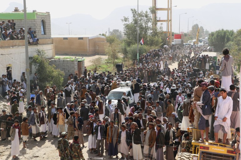 People gather to protest in front of an air strike center in Saada, Yemen