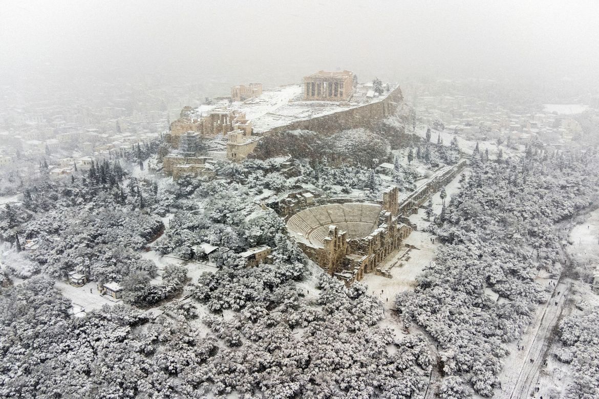 The Parthenon temple is seen atop the Acropolis hill, during heavy snowfall in Athens