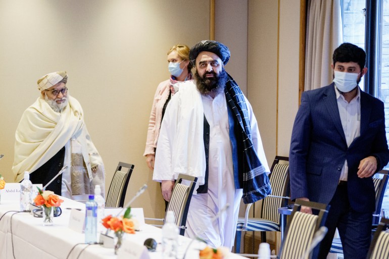Afghan Taliban's Foreign Minister Amir Khan Muttaqi and Taliban representative Mutiul Haq Nabi Kheel walk during a meeting with Norwegian officials