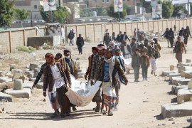 Relatives carry bodies of the victims of air strikes on a detention center to be buried at a cemetery in Saada