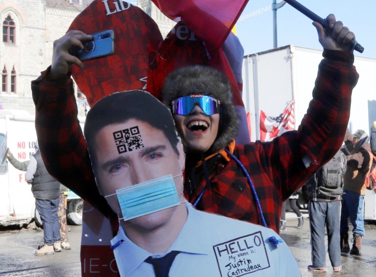 A protester wears a cutout image of Justin Trudeau during the protest in Ottawa