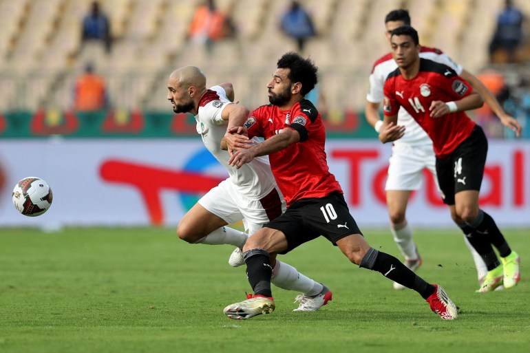 Soccer Football - Africa Cup of Nations - Quarter Final - Egypt v Morocco - Ahmadou Ahidjo Stadium, Yaounde, Cameroon - January 30, 2022 Morocco's Sofyan Amrabat in action with Egypt's Mohamed Salah REUTERS/Mohamed Abd El Ghany