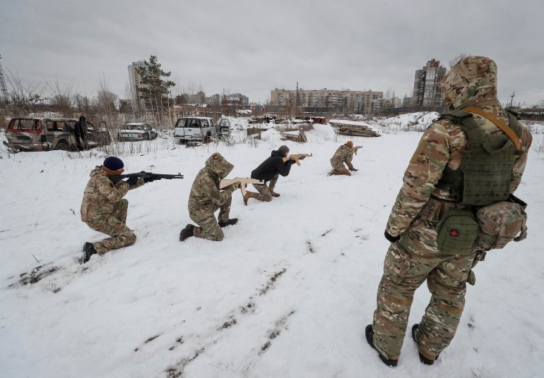 A veteran of the Ukrainian National Guard Azov battalion conducts military exercises for civilians in Kyiv