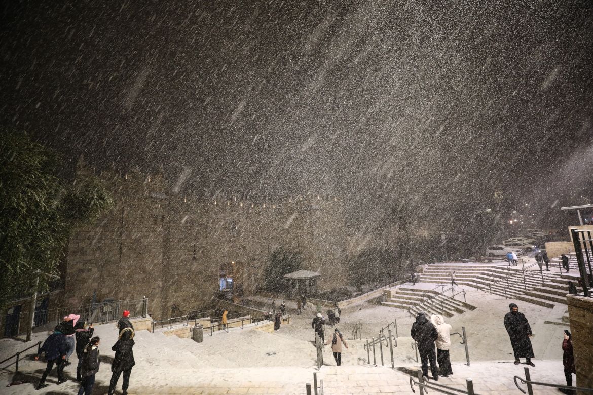 People gathering around Damascus Gate enjoy snow after snowfall in East Jerusalem on January 26,