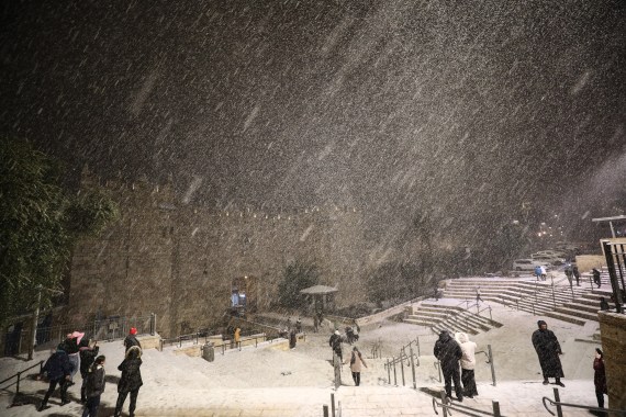 People gathering around Damascus Gate enjoy snow after snowfall in East Jerusalem on January 26,