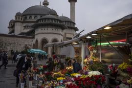 A customer browses flowers at a street florist in Istanbul, Turkey