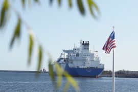 The U.S. national flag flies as the liquefied natural gas (LNG) tanker Oak Spirit, operated by Teekay Corp., sits docked with Poland's first import of U.S. LNG at the Gazoport terminal, operated by Polskie LNG SA, in Swinoujscie, Poland,