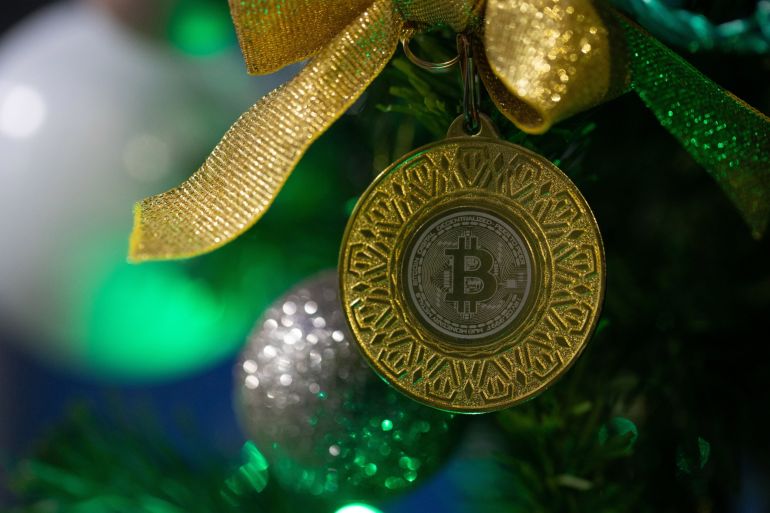 A novelty bitcoin decoration on a Christmas tree