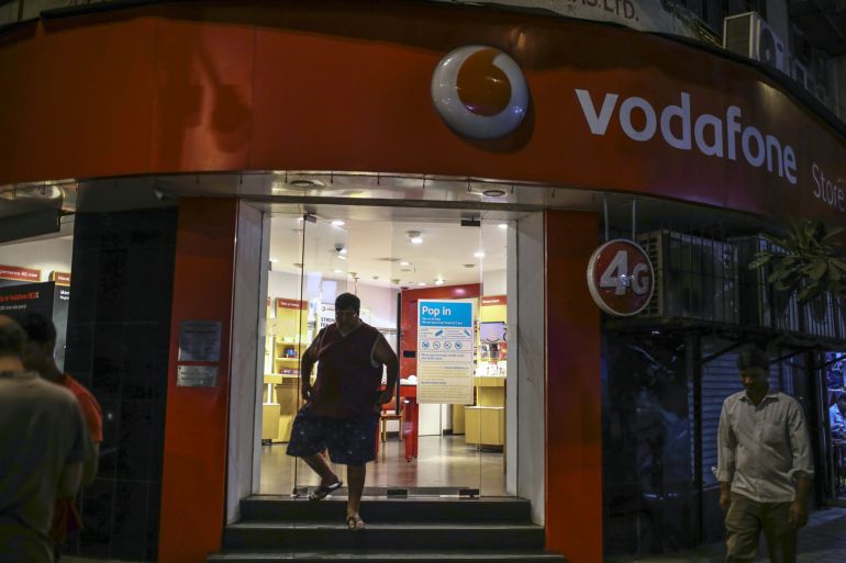 A customer exits a Vodafone Idea Ltd store in Mumbai, India.