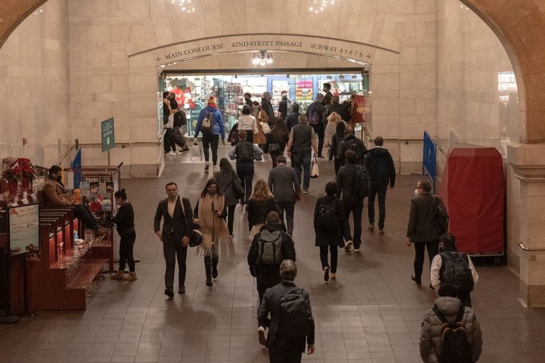 Commuters walk through Grand Central station during morning rush hour in New York
