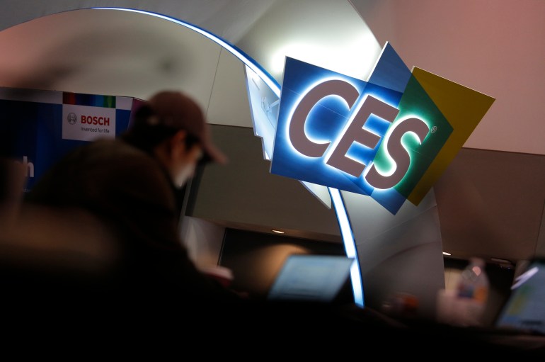 A worker helps set up a stand in front of CES International in January 2020