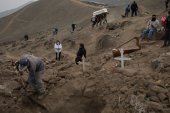 People are burying victims of COVID-19 at a cemetery on the outskirts of Lima, Peru on May 27, 2020 [File: AP/Rodrigo Abd]
