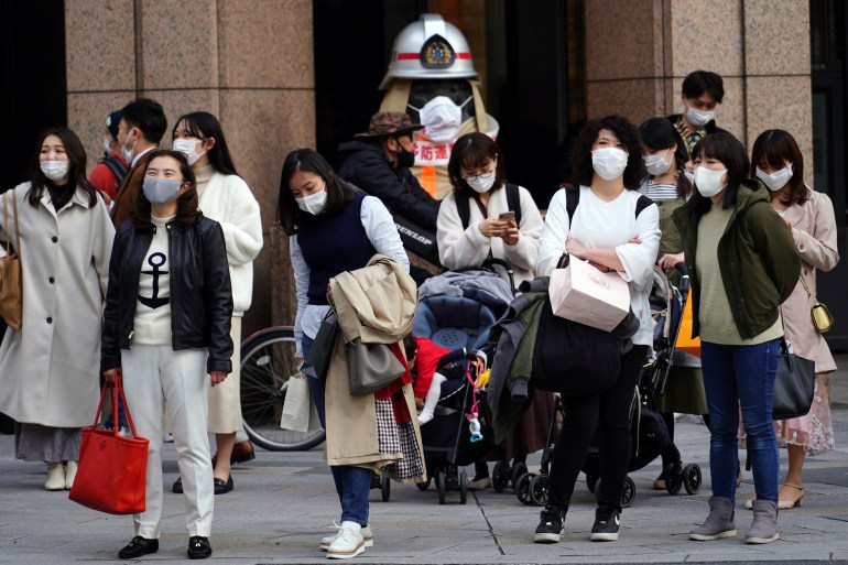 People wearing protective masks to help curb the spread of the coronavirus