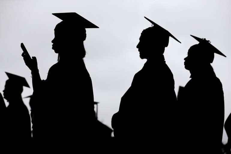 New graduates line up for a commencement