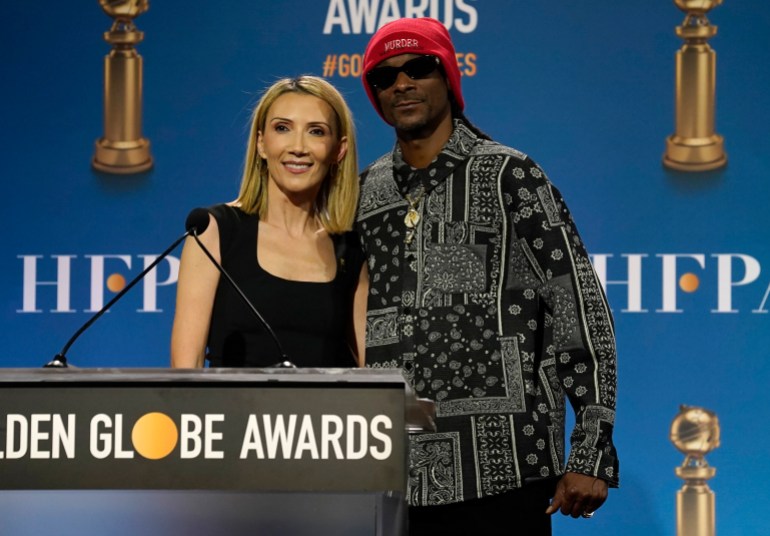 Helen Hoehne, president of the Hollywood Foreign Press Association and Snoop Dogg, poses after the nomination event for the 79th annual Golden Globe Awards