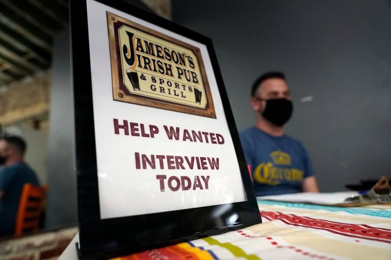 A hiring sign is shown at a booth for Jameson's Irish Pub during a job fair